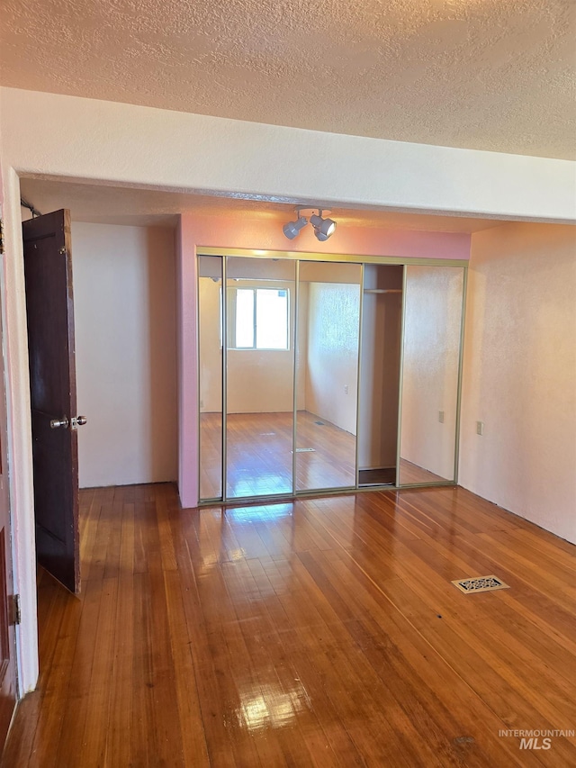 1922 9th Ave, Lewiston, ID 83501 - unfurnished bedroom with hardwood / wood-style floors and a textured ceiling