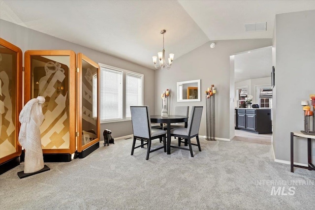 dining area featuring visible vents, baseboards, an inviting chandelier, vaulted ceiling, and light colored carpet