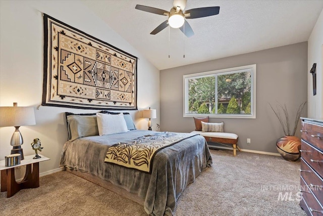 carpeted bedroom featuring baseboards, a textured ceiling, a ceiling fan, and vaulted ceiling