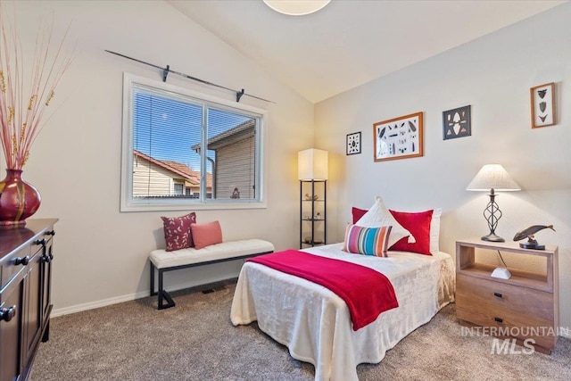 bedroom featuring baseboards, lofted ceiling, and carpet flooring