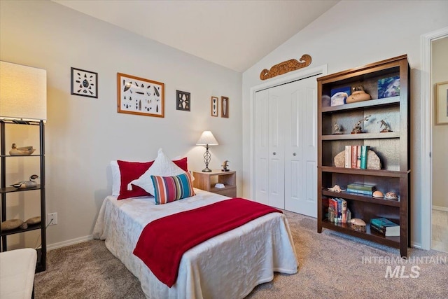 carpeted bedroom featuring vaulted ceiling, baseboards, and a closet