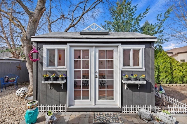 view of outbuilding featuring an outbuilding and fence