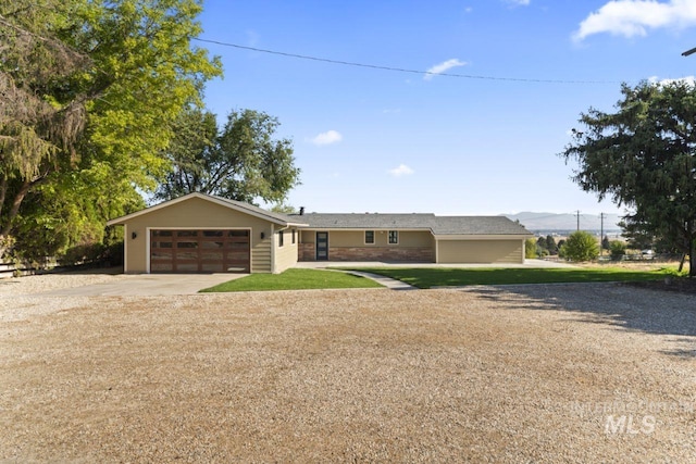 ranch-style house featuring a front yard and a garage