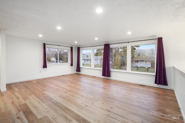 spare room featuring light hardwood / wood-style flooring