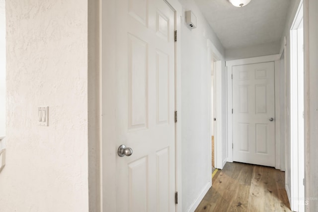 corridor with light hardwood / wood-style flooring