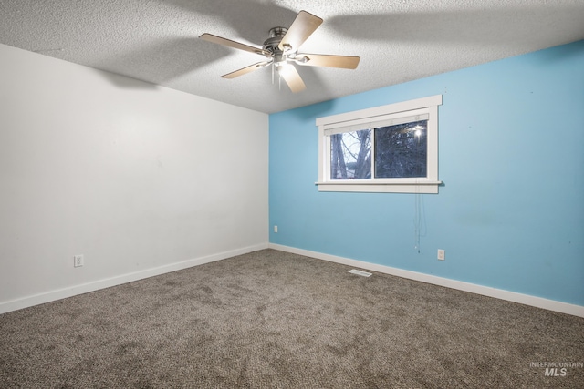 carpeted empty room with ceiling fan and a textured ceiling