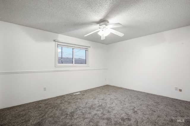 empty room featuring carpet, ceiling fan, and a textured ceiling