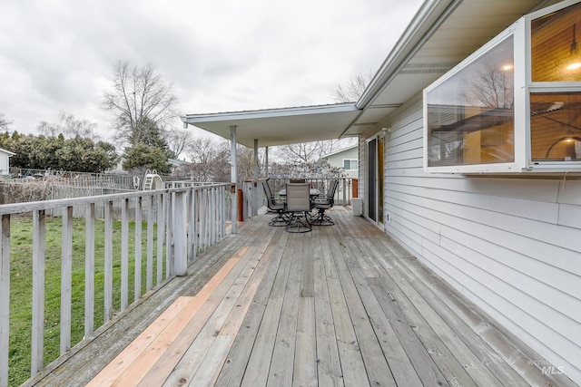 wooden deck with a lawn