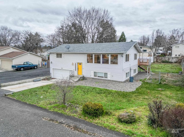 bi-level home featuring a front yard and a garage