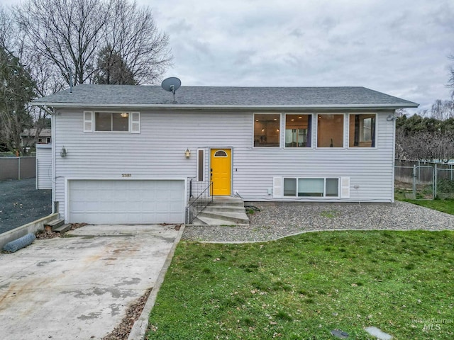 split foyer home with a front yard and a garage