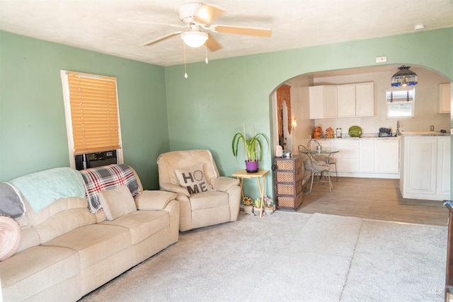 224 S Fern St, Nampa, ID 83686 - living area featuring arched walkways, ceiling fan, and light colored carpet