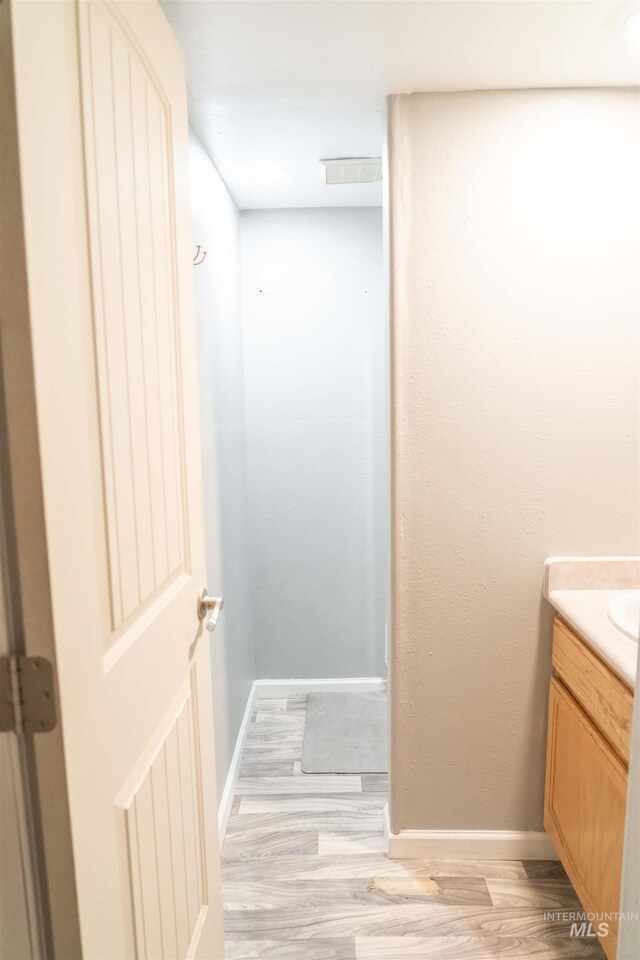 224 S Fern St, Nampa, ID 83686 - bathroom with vanity, wood finished floors, and baseboards