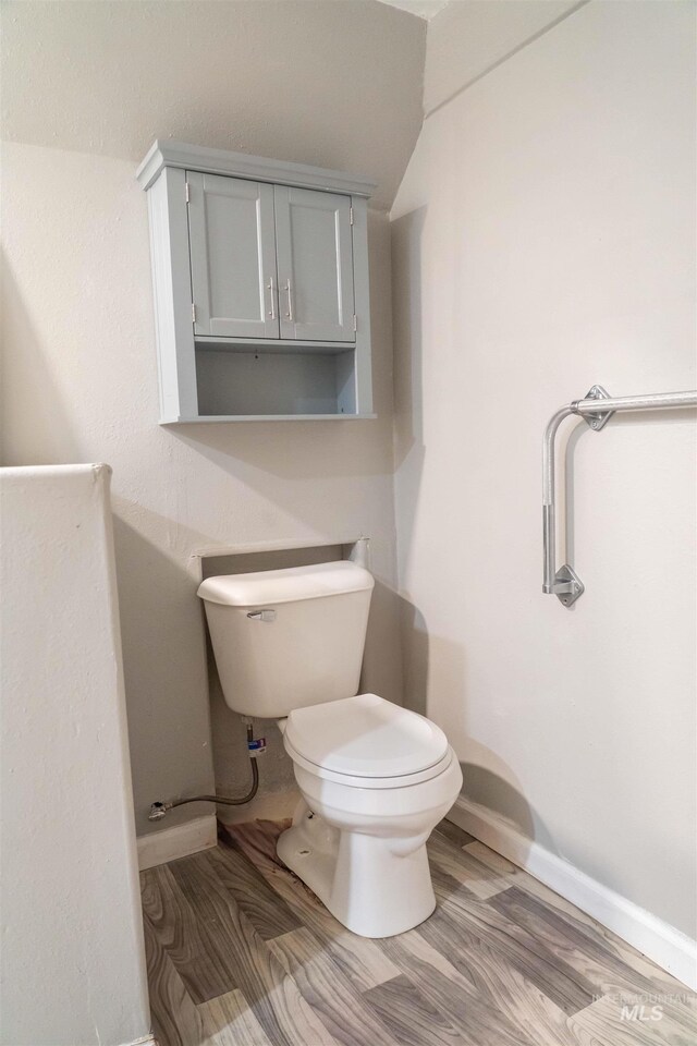 224 S Fern St, Nampa, ID 83686 - half bathroom featuring toilet, baseboards, wood finished floors, and lofted ceiling