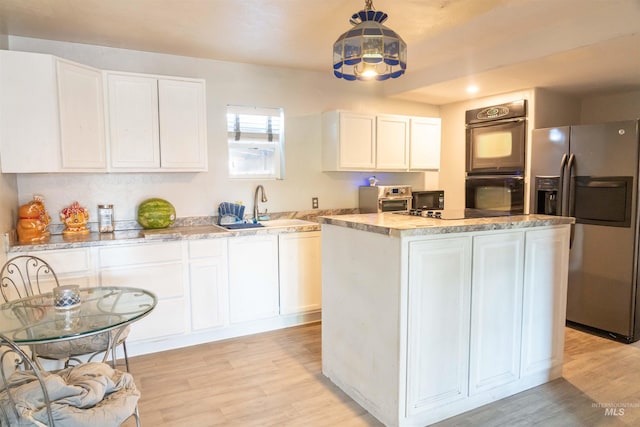 224 S Fern St, Nampa, ID 83686 - kitchen featuring black appliances, light wood-type flooring, a sink, and white cabinets