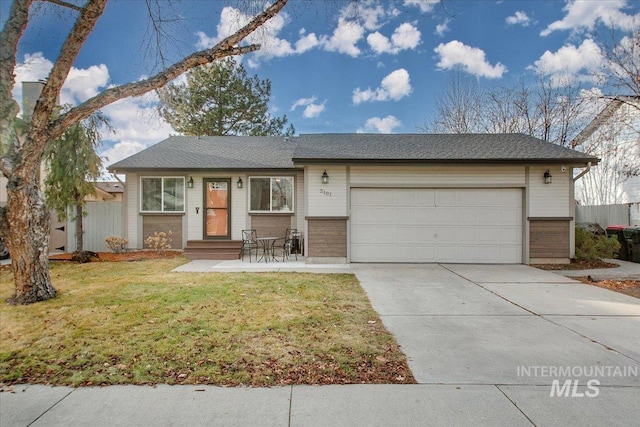 ranch-style house featuring a front yard and a garage