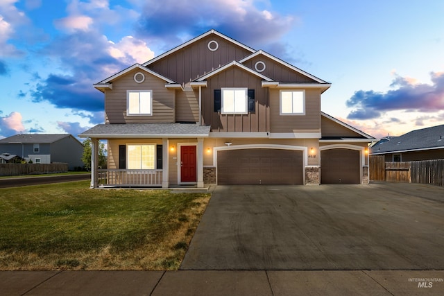 4618 Braeburn Ave, Caldwell, ID 83607 - view of front of home with a porch, driveway, board and batten siding, and stone siding