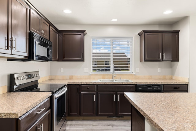 4618 Braeburn Ave, Caldwell, ID 83607 - kitchen featuring black appliances, dark brown cabinets, recessed lighting, light countertops, and light wood-style floors