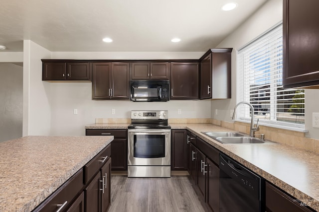 4618 Braeburn Ave, Caldwell, ID 83607 - kitchen featuring black appliances, dark brown cabinets, dark wood-style floors, recessed lighting, and light countertops
