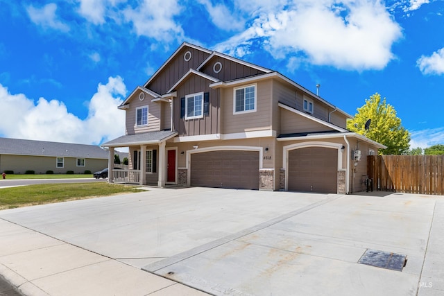 4618 Braeburn Ave, Caldwell, ID 83607 - view of front of house with board and batten siding, a porch, an attached garage, and driveway
