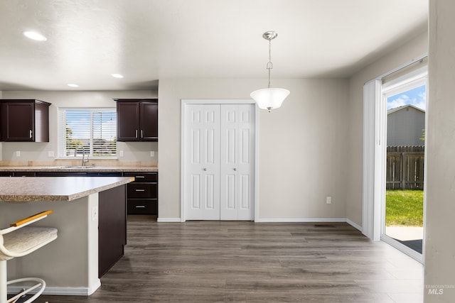 4618 Braeburn Ave, Caldwell, ID 83607 - kitchen featuring dark brown cabinets, dark wood-style flooring, recessed lighting, pendant lighting, and light countertops