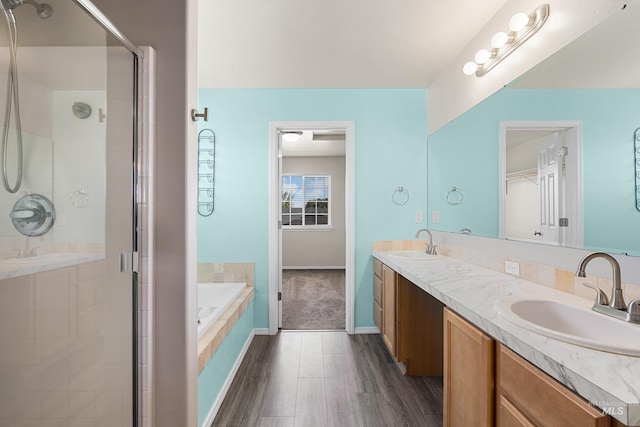 4618 Braeburn Ave, Caldwell, ID 83607 - bathroom with a stall shower, wood finished floors, a bath, and double vanity