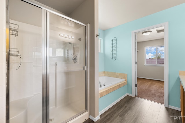4618 Braeburn Ave, Caldwell, ID 83607 - full bath with a bath, a shower stall, vanity, and wood finished floors