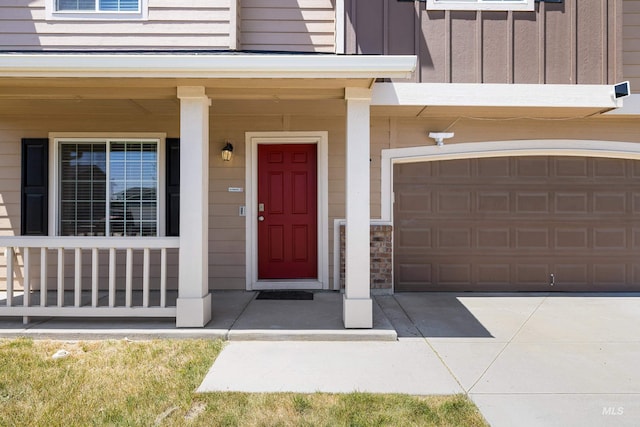 4618 Braeburn Ave, Caldwell, ID 83607 - property entrance with board and batten siding, a porch, and an attached garage