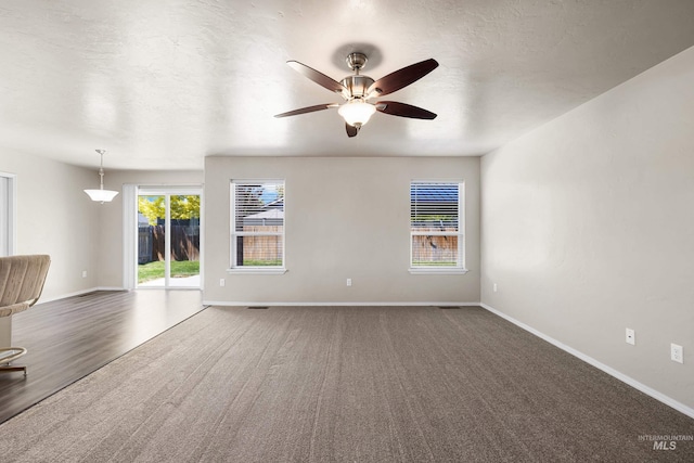 4618 Braeburn Ave, Caldwell, ID 83607 - unfurnished living room featuring a ceiling fan and carpet