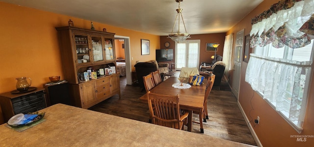 817 6th St, Kamiah, ID 83536 - dining room with dark wood-style flooring and baseboards