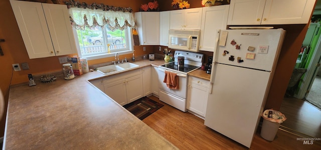 817 6th St, Kamiah, ID 83536 - kitchen with white appliances, a sink, white cabinets, and light countertops