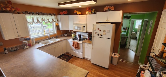 817 6th St, Kamiah, ID 83536 - kitchen with white appliances, a sink, white cabinets, light wood-style floors, and light countertops