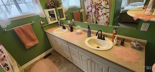 817 6th St, Kamiah, ID 83536 - full bath with double vanity, tile patterned floors, and baseboards