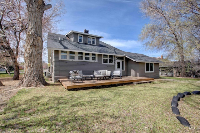 back of property with fence, an outdoor hangout area, a yard, and a deck