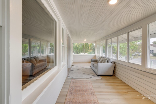 sunroom featuring wood finished floors and wooden ceiling