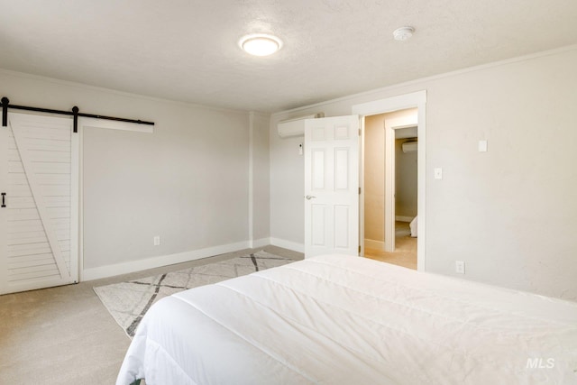 bedroom with a barn door, a wall mounted AC, carpet floors, and ornamental molding