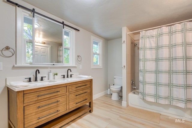 full bath with shower / tub combo with curtain, wood finished floors, a sink, and double vanity