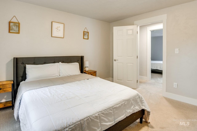carpeted bedroom featuring baseboards