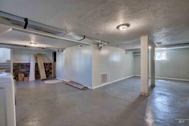 basement featuring washer / dryer, visible vents, and baseboards
