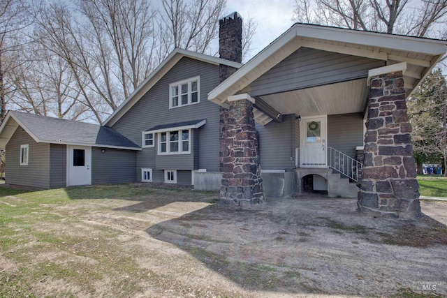 back of property with a chimney