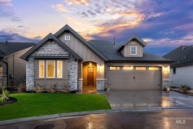 craftsman inspired home featuring a garage and a yard