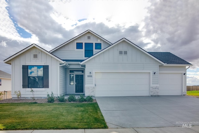 view of front of property with a garage and a front lawn