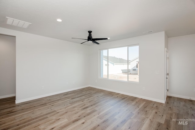 spare room featuring light hardwood / wood-style floors and ceiling fan