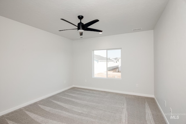 unfurnished room featuring ceiling fan and carpet