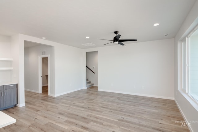 unfurnished living room featuring light wood-type flooring and ceiling fan