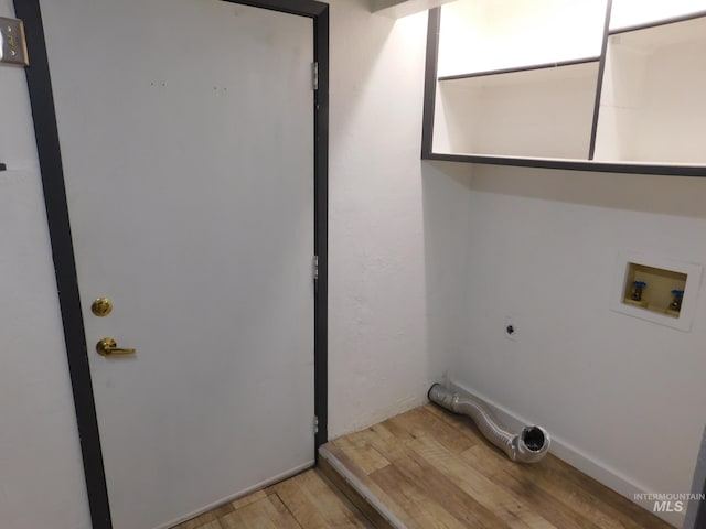 laundry room featuring laundry area, hookup for an electric dryer, hookup for a washing machine, and light wood-type flooring