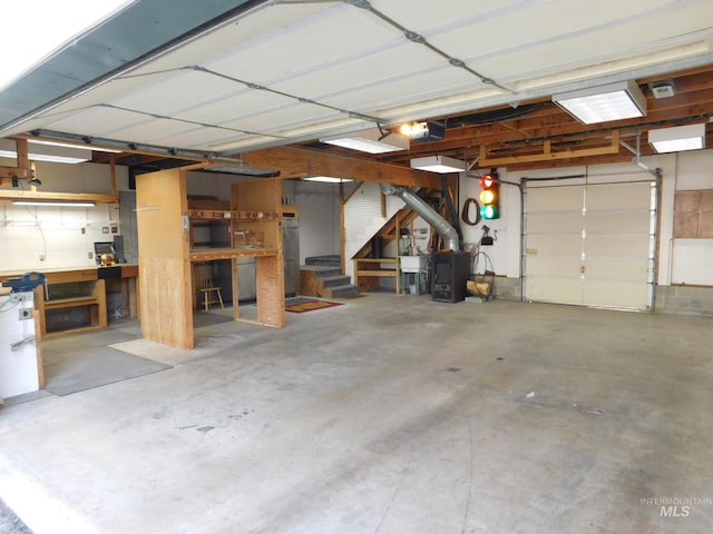 garage with a garage door opener and a workshop area