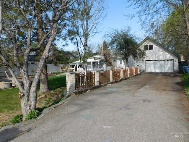 view of home's exterior with a fenced front yard and driveway