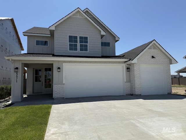 6671 W Mattawa Dr, Meridian, ID 83646 - view of front of property with driveway, roof with shingles, board and batten siding, a garage, and brick siding