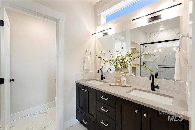 full bathroom featuring a marble finish shower, marble finish floor, backsplash, and a sink