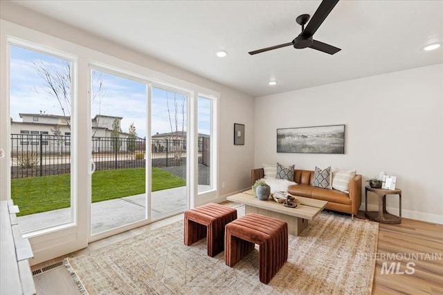 living room with recessed lighting, light wood-style floors, baseboards, and ceiling fan